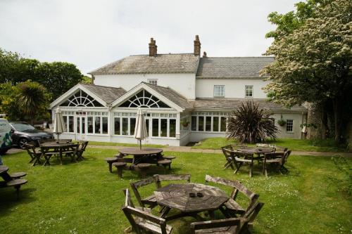 a group of tables and chairs in front of a building at The Grove in St. Davids