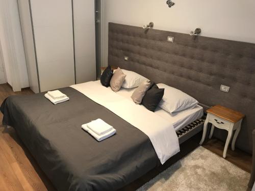 a large bed with two towels on top of it at Pula Antic Rooms in Center in Pula