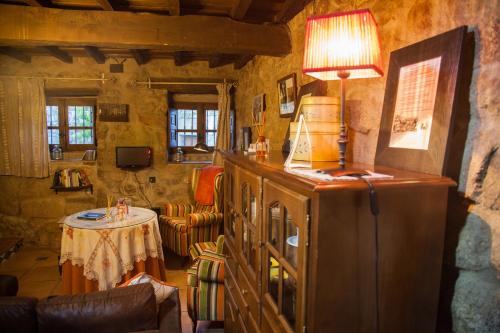 a living room with a refrigerator and a table at El Balcon de Los Sueños in Trevejo