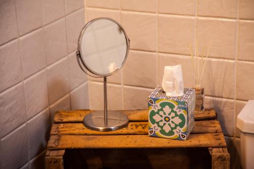 a mirror on a wooden table next to a box of tissues at El Balcon de Los Sueños in Trevejo