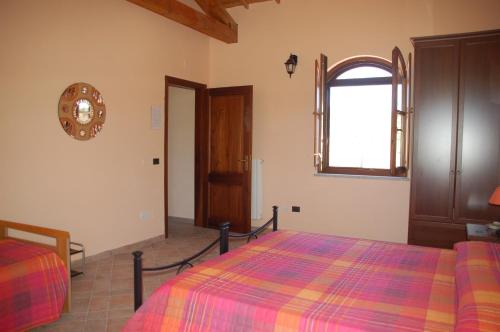 a bedroom with a bed with a colorful blanket at B&B Nuraximannu in Santadi
