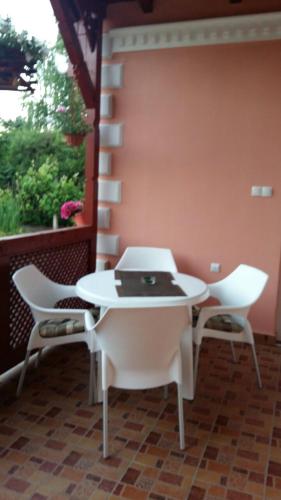 a white table and chairs on a patio at Villa Sunset in Palić