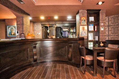 a bar in a restaurant with a table and chairs at Luxury Sea Residence by Kristina in Tivat