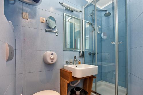 a bathroom with a sink and a shower at Luxury Sea Residence by Kristina in Tivat