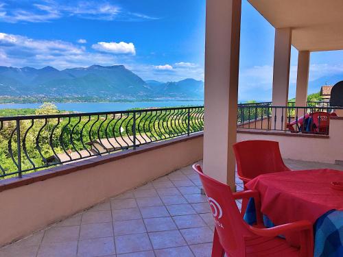 a balcony with a table and chairs and a view at Residence Bellavista in Manerba del Garda