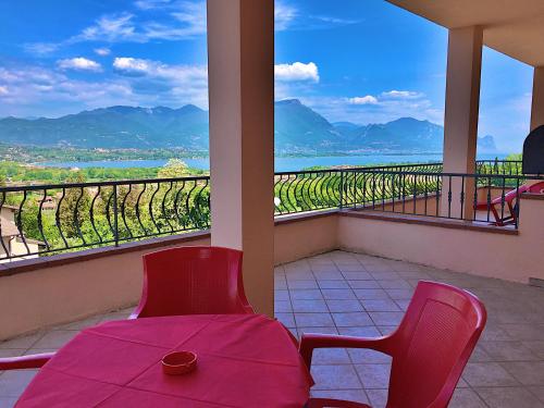 a room with a table and chairs and a view of a vineyard at Residence Bellavista in Manerba del Garda