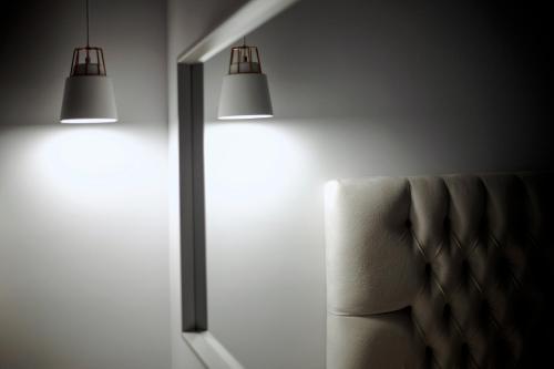 a living room with a chair and two lights at Liberte Maisonettes in Parga