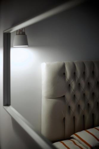 a room with a bed with a light on it at Liberte Maisonettes in Parga