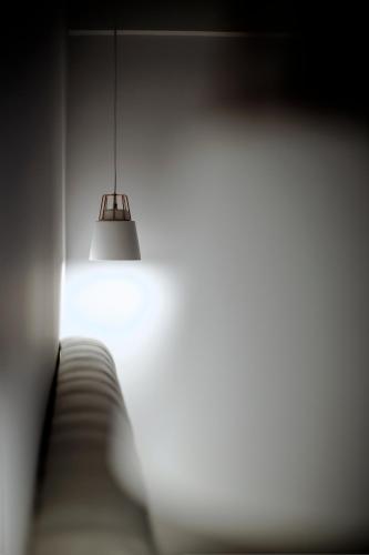 a light fixture hanging from a wall in a room at Liberte Maisonettes in Parga