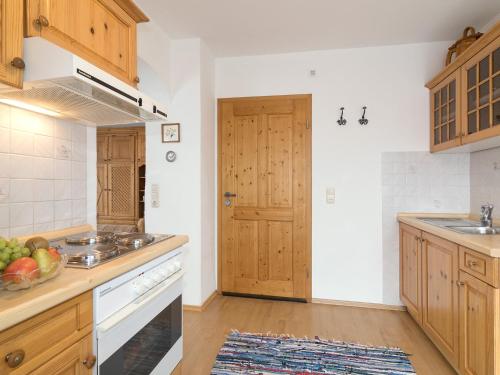 a kitchen with a sink and a stove top oven at Ferienwohnungen Blos in Grassau