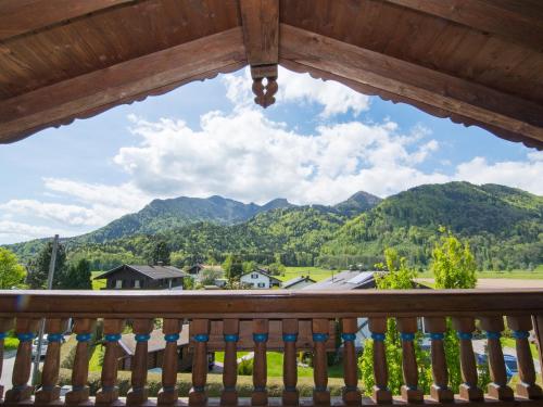 a view from the balcony of a cabin with mountains at Ferienwohnungen Blos in Grassau