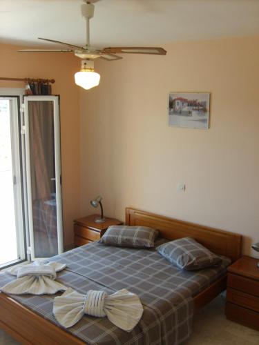 a bedroom with a bed with two pillows on it at Gouna's Aparts in Xi