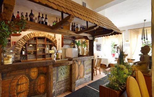 a bar in a restaurant with a brick wall at Hotel zur Post Kleve in Kleve