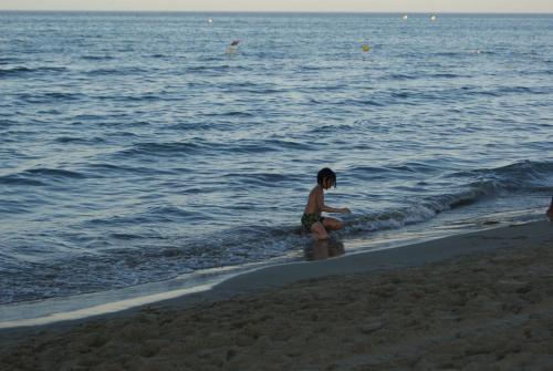 a young child playing in the water at the beach at Appartement Miradorgolf in Cabo Negro