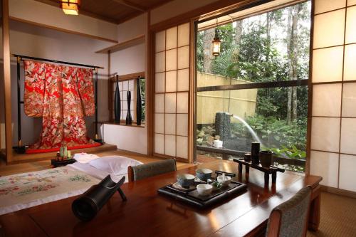 a bedroom with a bed and a large window at Colmar Tropicale in Bukit Tinggi