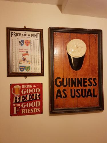 two posters on a wall with a cup of coffee at O'Loughlin's Bar in Miltown Malbay