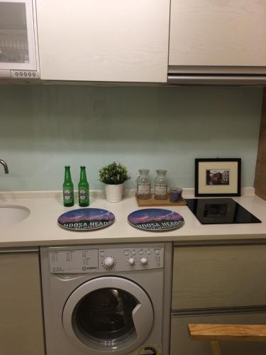 a kitchen with a washing machine on a counter at 巴黎Villa 主題派對K歌 BBQ 麻將包棟 in Luodong