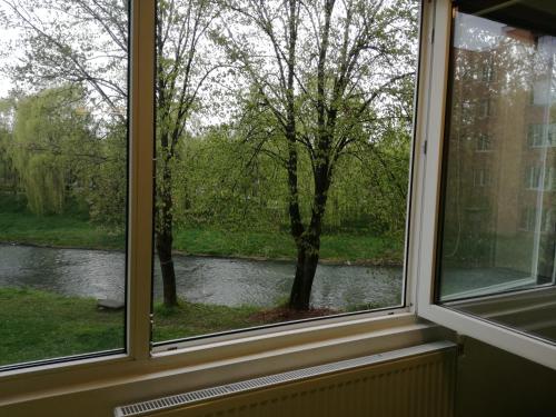 a window with a view of a river at Green Apartment in Odorheiu Secuiesc