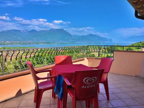 a table and chairs with a view of a vineyard at Residence Bellavista in Manerba del Garda