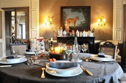 a table with a black table cloth and candles on it at Saint Victor La Grand' Maison in Ingrandes