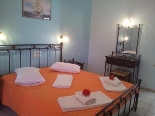 a large orange table with towels and a mirror at Kaspy Country Houses in Lygia