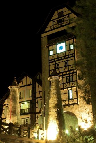 a large building with a clock tower at night at Colmar Tropicale in Bukit Tinggi