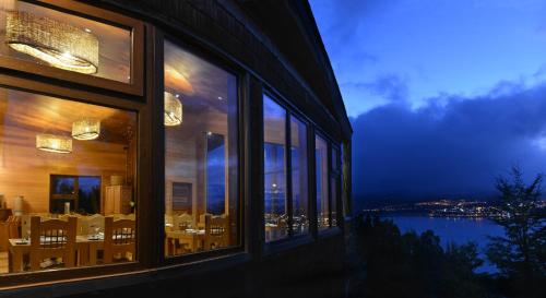 a building with windows with a view of the water at OCIO Territorial Hotel in Castro