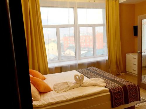 Кровать или кровати в номере Гостевые комнаты Апельсин на Сретенском Бульваре