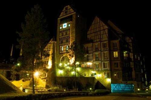 a large building with lights on it at night at Colmar Tropicale in Bukit Tinggi