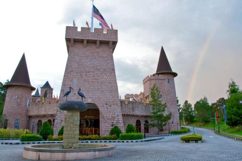 a castle with a rainbow in the background at Colmar Tropicale in Bukit Tinggi