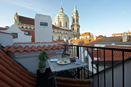 a plate of food on a table on a balcony at Residence U Mecenáše in Prague