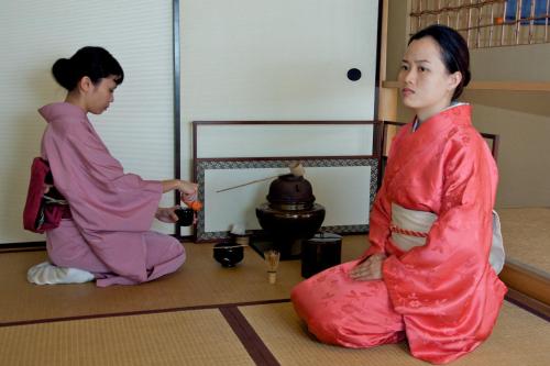 two women in kimonos sitting on the floor at Colmar Tropicale in Bukit Tinggi
