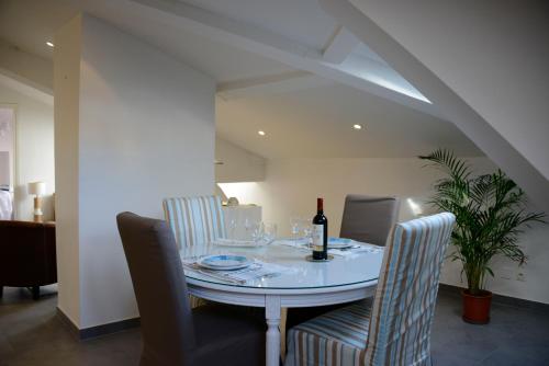Un comedor con una mesa con una botella de vino. en Cannes,croisette,palais des festivals,plages, en Cannes