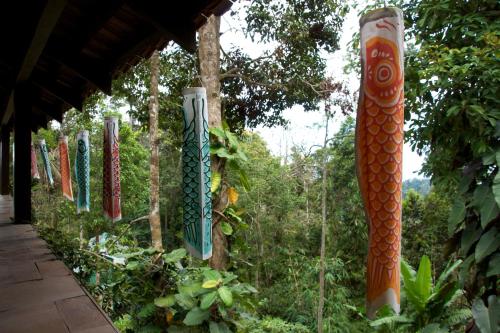 a row of colorful glass ornaments hanging from trees at Colmar Tropicale in Bukit Tinggi