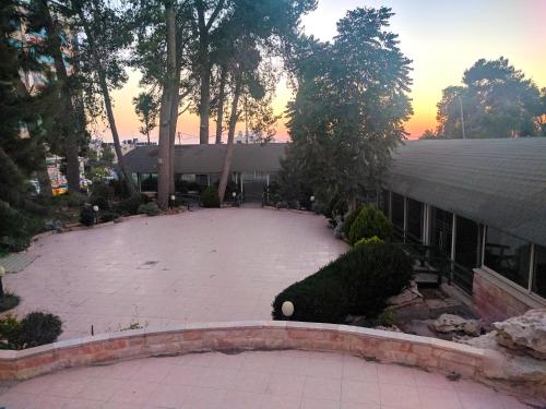 a large patio in front of a building at Alhambra Palace Hotel Suites - Ramallah in Ramallah