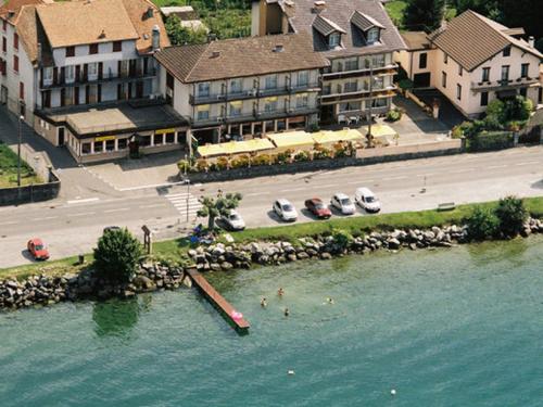 an aerial view of a resort with boats in the water at Hôtel Restaurant le Panorama in Évian-les-Bains