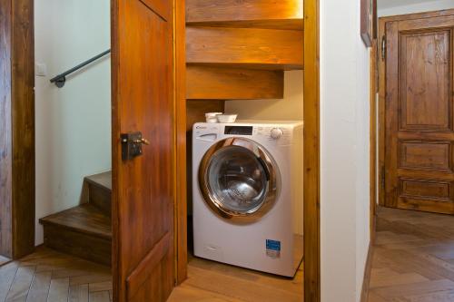 a washer and dryer in a room with a door at Residence U Mecenáše in Prague