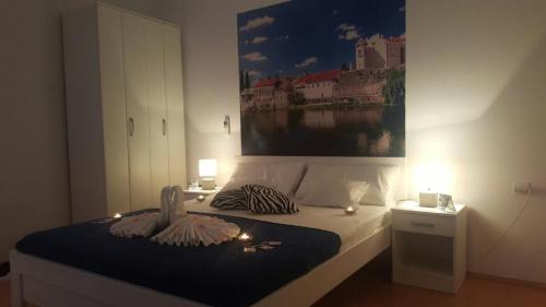 a bedroom with a bed with candles and a painting at Apartment Maša in Trebinje