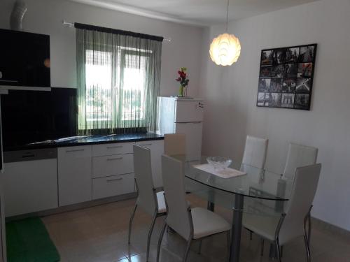 a kitchen with a table and chairs and a refrigerator at Villa Perlla in Split