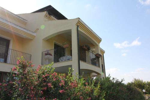 a building with balconies and flowers in front of it at Palmas Dorada Home in Olmedo