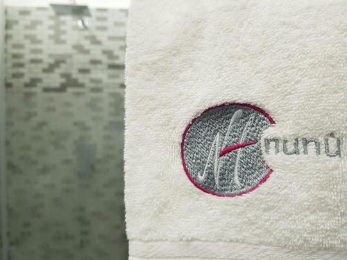 a close up of a logo on a towel at Hotel Nunù in Naples