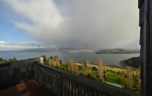 a view of a rainbow from a balcony at OCIO Territorial Hotel in Castro