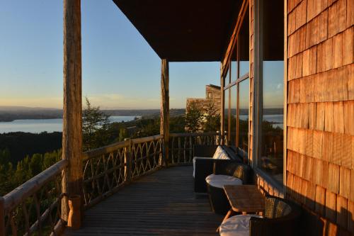 a porch with chairs and a view of the water at OCIO Territorial Hotel in Castro