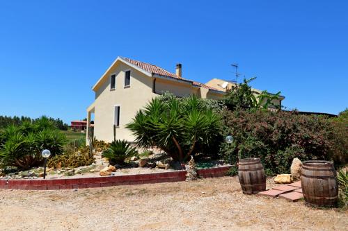 a house with two barrels in front of it at Palmas Dorada Home in Olmedo