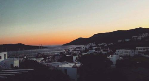 a view of a city with the sunset in the background at Studios Angela Village in Lipsoi