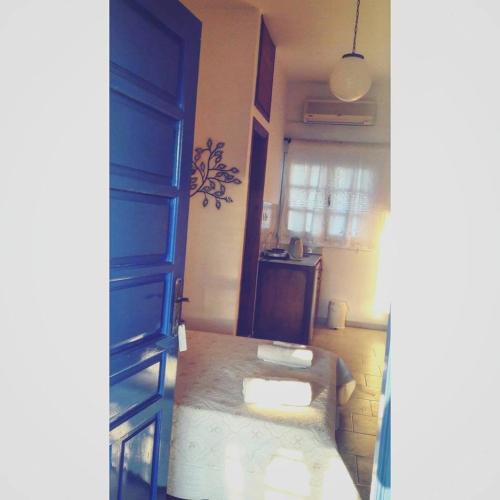 a small room with a bed and a window at Studios Angela Village in Lipsoi