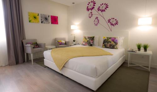Voodi või voodid majutusasutuse Primavera Perfume Hotel toas