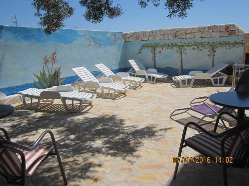 a group of chairs and tables on a patio at Apartments Villa Bella Vista Hvar in Hvar