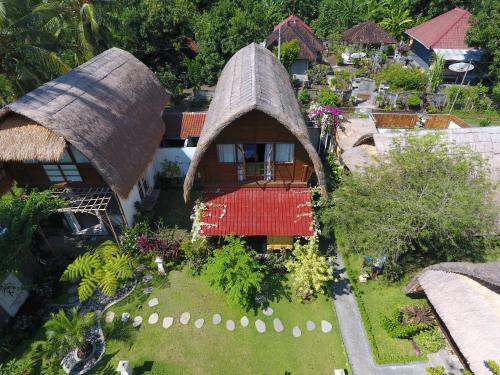 an aerial view of a house with a grass roof at Aura Villa & Spa Amed Bali in Amed