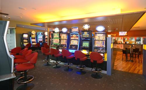 a bunch of slot machines in a casino at Bridge Hotel in Smithton